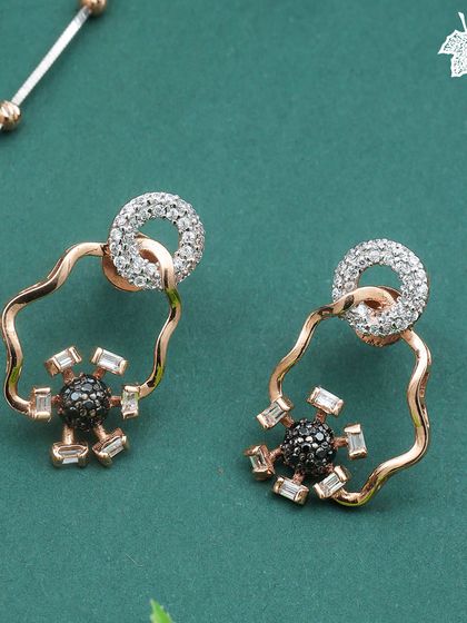 The Eclipse Glow earrings, featuring a unique combination of black and white diamonds for a bold, graphic look.