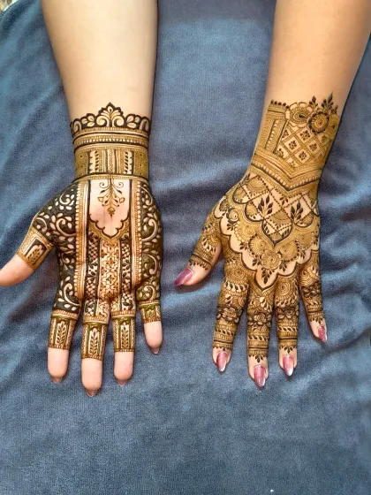 The complete bridal look. One hand features a geometric, architectural style, while the other has a more organic, flowing design, showing how we can play with different themes.