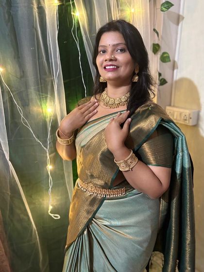 I love how this light green and gold saree brings out the warmth of the temple jewellery. This set includes a choker, bangles, and a kamarband.