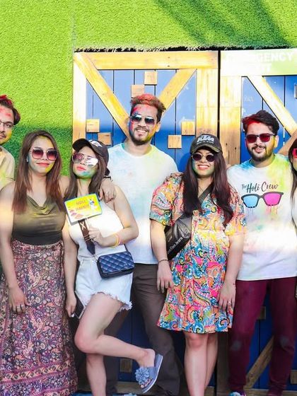 A group of friends posing for a picture at the Holi party's photo booth.