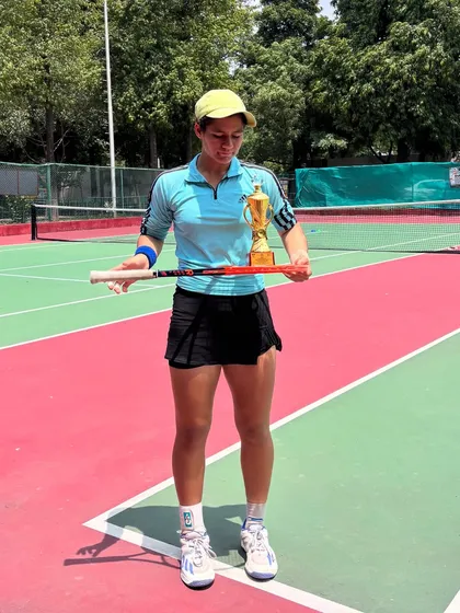 Full-length shot of Riya with her trophy from the Chandigarh tournament. We focus on developing all-court players who can compete and win on any surface.