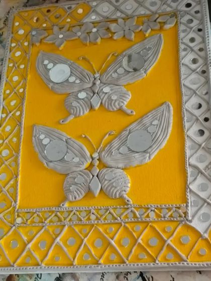 This completed Lippan art panel showcases the beautiful combination of textured clay and reflective mirror work. In our classes, you'll create your own decorative piece from start to finish.