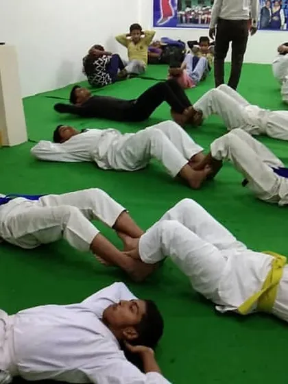 Core strength is crucial. Students engage in conditioning exercises during a training session to build the physical foundation needed for powerful techniques.