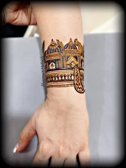 A beautifully shaded cuff design with peacock details, showing the depth and dimension we can create with henna.