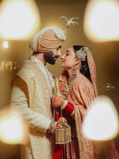 An artistic shot of the beautiful Sikh couple. The bride's side profile highlights her intricate jewelry and the soft, glowing makeup I created for her Anand Karaj.