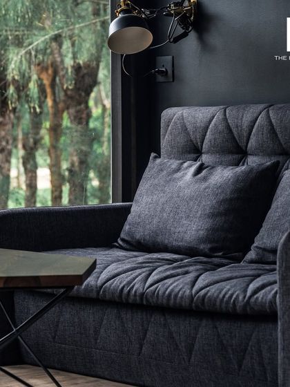 Minimalist interior design is about creating a peaceful and elegant environment. This image shows a comfortable sofa with clean lines and simple forms, where every detail is thoughtfully chosen for a calm, harmonious living space.