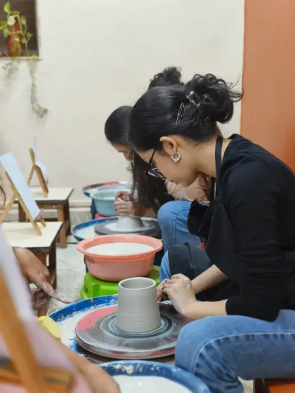Students work diligently on their pieces at the pottery wheel. Our classes provide a focused environment for learning and honing your skills.