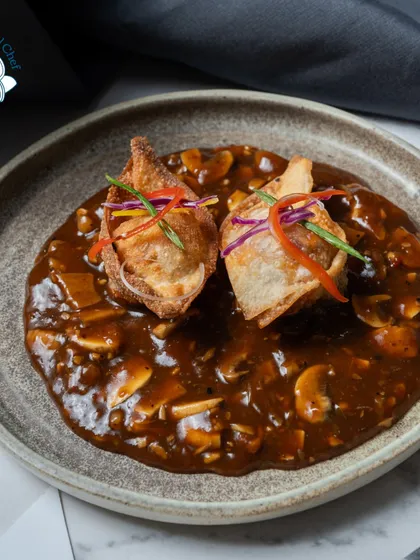 My pan-fried chicken dumplings in a simmered mushroom broth are a savory and soul-warming dish, perfect for a corporate dinner or a festive celebration.