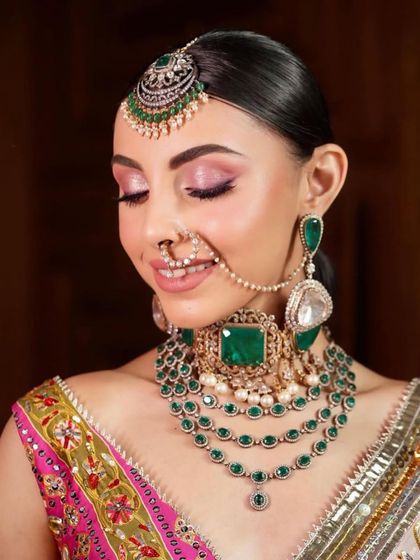 A close-up of a happy bride. This look features a soft pink smokey eye and a radiant smile, capturing a moment of joy. The makeup is designed to look fresh and beautiful all day long.