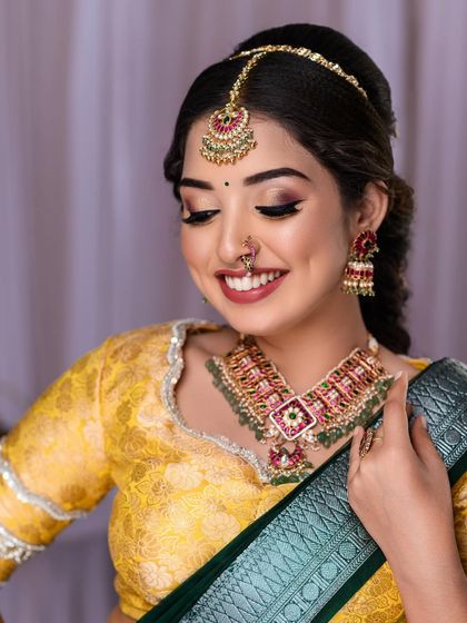 A close-up with eyes closed, showcasing the soft pink and gold eyeshadow work.