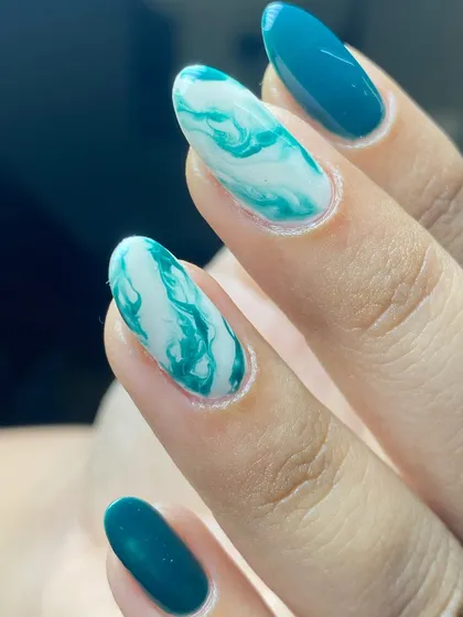 A close-up showing the beautiful swirls in the marble nail art.