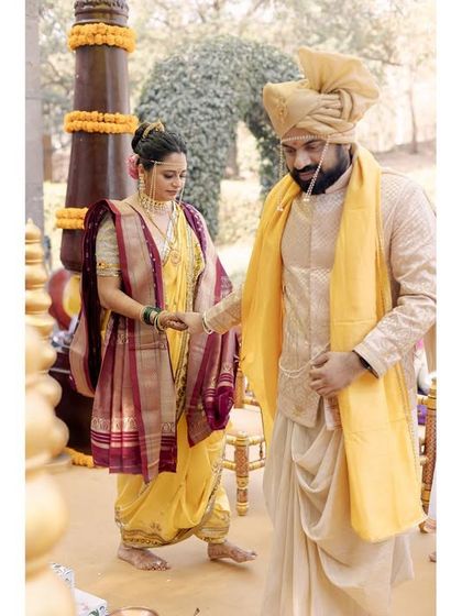 The couple during their Maharashtrian wedding ceremony. This shot captures a moment of ritual, showing the traditional attire and the solemnity of the proceedings.