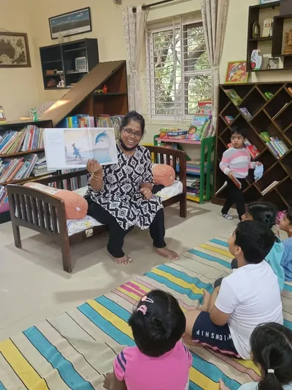 The storyteller shows a picture of a dolphin, sparking a discussion about marine life and conservation.