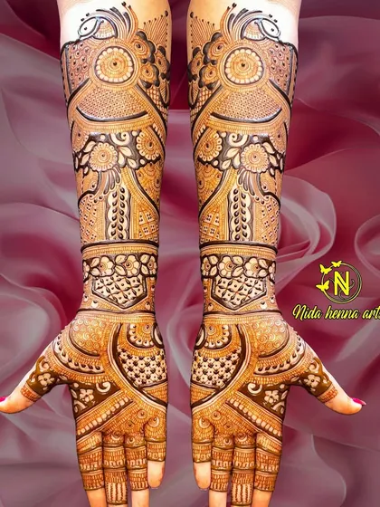 The back of the hands for the same bridal client, showing a consistent design language. The patterns complement the front, featuring peacock motifs and intricate line work.