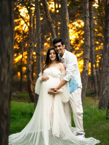 There's nothing like the magic of golden hour. This outdoor maternity session captures a couple's love in the warm, dreamy light of a forest setting, creating a truly romantic and timeless memory.