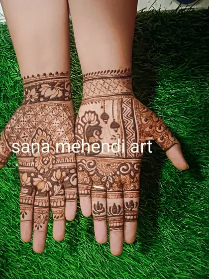 A Teej mehndi design with peacock, jhumka, and lotus motifs.