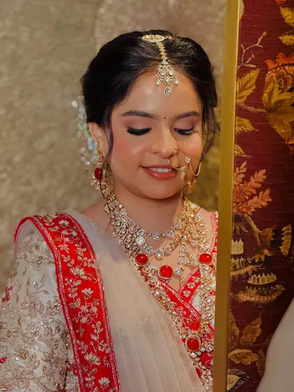 A close-up on the soft, shimmering eye makeup and the flawless skin that defines this regal bridal look.