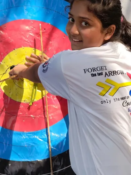 "Forget the last arrow, only the next one counts." A student wearing our club motto proudly while scoring her target.