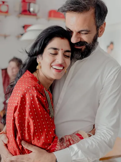 The pure joy of a homecoming. This candid embrace between the newlyweds captures the warmth and happiness of starting a new life together in their own home.