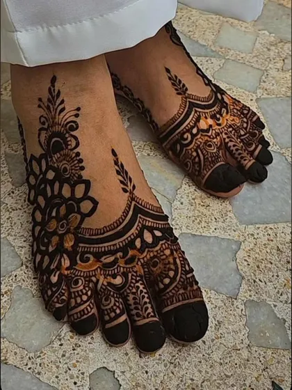 A bold Karachi-style henna design for the feet. The thick lines and dark-filled areas create a very striking look.
