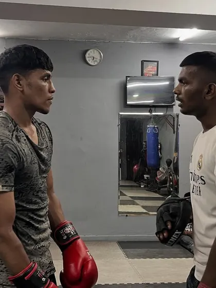 The intense stare-down between two boxers before a drill. This focus and mutual respect are at the core of the sport.