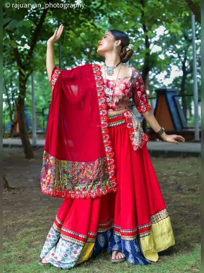 Capturing the vibrant energy of ethnic fashion in an outdoor setting. This dynamic shot of a model in a red chaniya choli shows how I use movement and natural environments to create lively and expressive portraits.