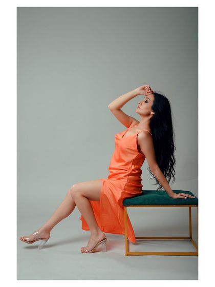 An elegant and graceful portrait in a satin dress. The pose and lighting create a sophisticated and timeless image.