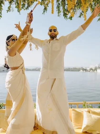 A couple shares a dance at their lakeside Haldi ceremony in Udaipur. We encourage creating moments of spontaneous joy, ensuring the celebration feels authentic and full of love.
