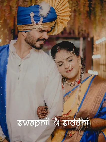 A classic Maharashtrian wedding portrait. The bride, radiant in her traditional yellow and blue Nauwari saree, rests peacefully against her groom, showcasing the serene beauty and cultural richness of the lagn.