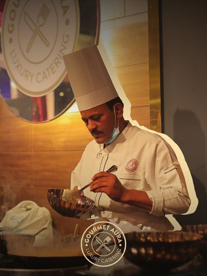 A chef in his element, focused on meticulously preparing a dish over a steaming pot. This image captures the precision and passion that defines our kitchen.
