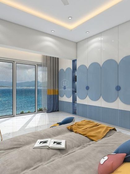 A kid's room with a beautiful sea view. The design incorporates shades of blue and yellow, with custom rounded wardrobe doors and a dedicated study area by the window.