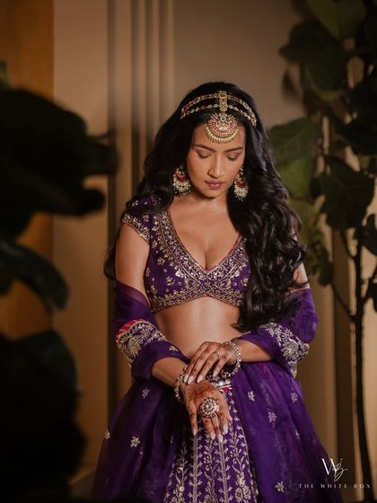 A close up of Shubhangi's Sangeet makeup, highlighting the beautiful eyeshadow blend and the intricate mathapatti.