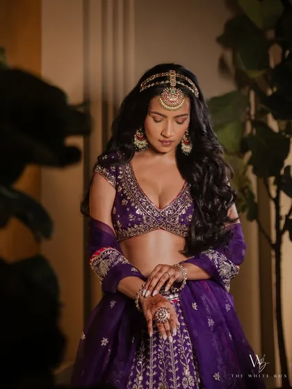 A close up of Shubhangi's Sangeet makeup, highlighting the beautiful eyeshadow blend and the intricate mathapatti.