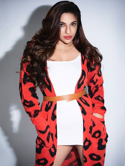 A standing portrait with a belted cardigan, demonstrating versatile styling within the same shoot. This provides clients with a variety of options for their portfolio or brand campaign.