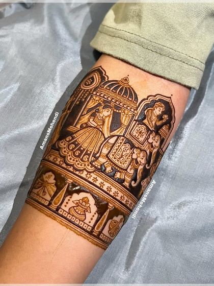 The completed doli scene, with the henna paste creating a bold, dark outline. This traditional element is a favorite for brides wanting to capture the wedding journey.