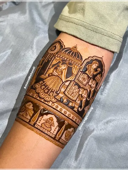 The completed doli scene, with the henna paste creating a bold, dark outline. This traditional element is a favorite for brides wanting to capture the wedding journey.