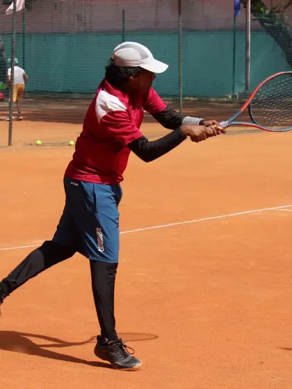 A player executing a solid backhand volley. We train our players to be comfortable and aggressive at the net.