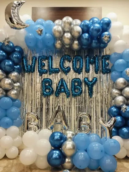 Another angle of the blue, white, and silver 'Welcome Baby' wall decoration.