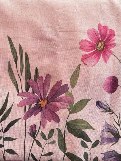 A close-up of our jute daman printed fabric, showing the beautiful texture of the jute and the artistic floral design.