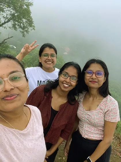 A selfie of four friends enjoying the misty weather on a trek. Solo travelers often leave with a new group of friends.