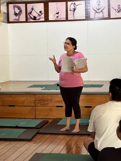 Learning is a conversation. Here, I am speaking to the class, holding my notes, ensuring the sequence is precise and tailored to their needs. Every student feels seen and heard.