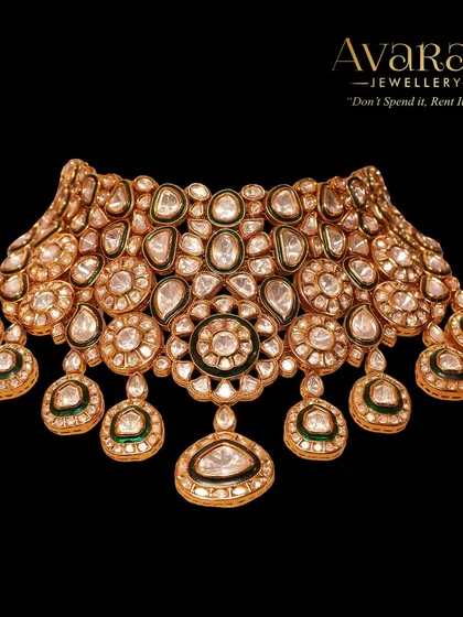 This stunning polki choker is a masterpiece of traditional craftsmanship. The intricate design and high-quality stones make it a perfect centerpiece for any bride's jewellery collection.
