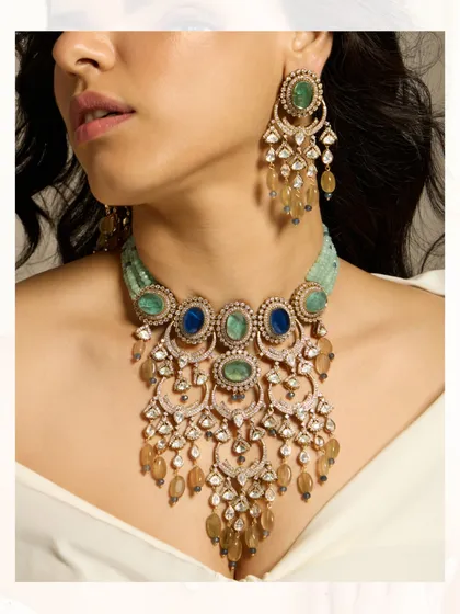 A vibrant layered necklace combining blue and green stones with polki and pearl drops for a colorful and festive look.
