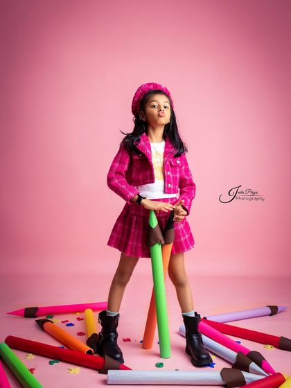 Attitude and style for a seventh birthday. The 'Back to School' theme uses oversized pencil props and a colorful wardrobe to create a fun, fashion-inspired shoot.