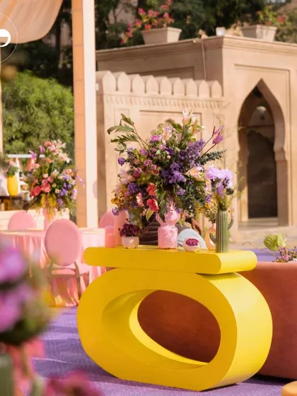 A view of the eclectic seating arrangement at our Moroccan-themed party. The mix of modern yellow consoles, blush-toned seating, and lush floral centerpieces created a vibrant and opulent atmosphere.