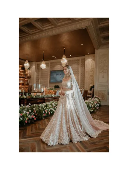 A full-length shot of Suchita in her gorgeous Tarun Tahiliani lehenga. This photo showcases the entire bridal look, from the long, flowing veil to the intricate embroidery of the gown.