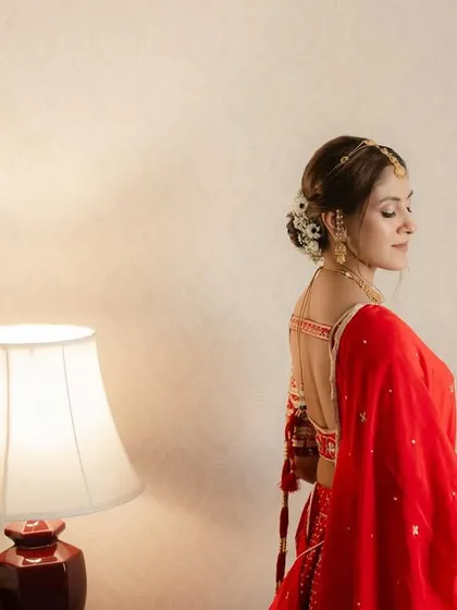 A beautiful shot showing the back of the bridal lehenga and the elegant hairstyle, all coming together for a picture-perfect look.