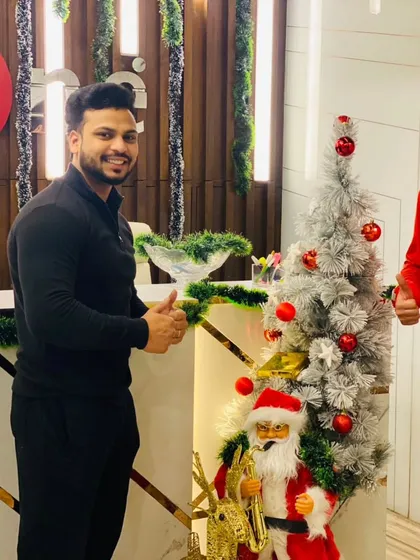 Two members giving a thumbs up, celebrating the festive season together at the gym. Our community is the heart of our brand.
