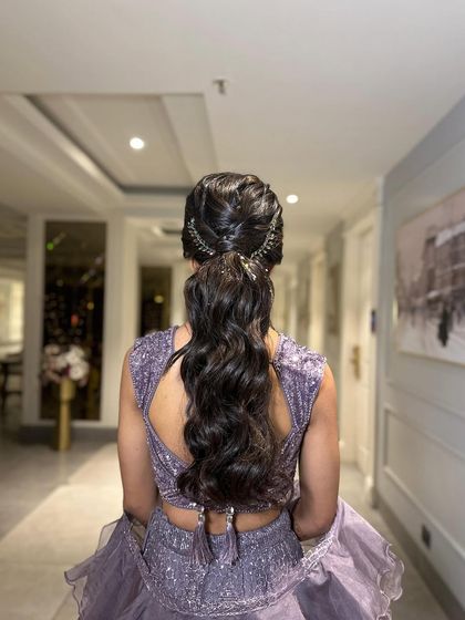 This messy ponytail features a braided crown for added texture and detail. It's a beautiful blend of bohemian and chic.