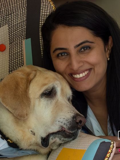 A tender moment between a woman and her senior Labrador, Scotch. This image beautifully captures the deep, lasting bond built over many years.